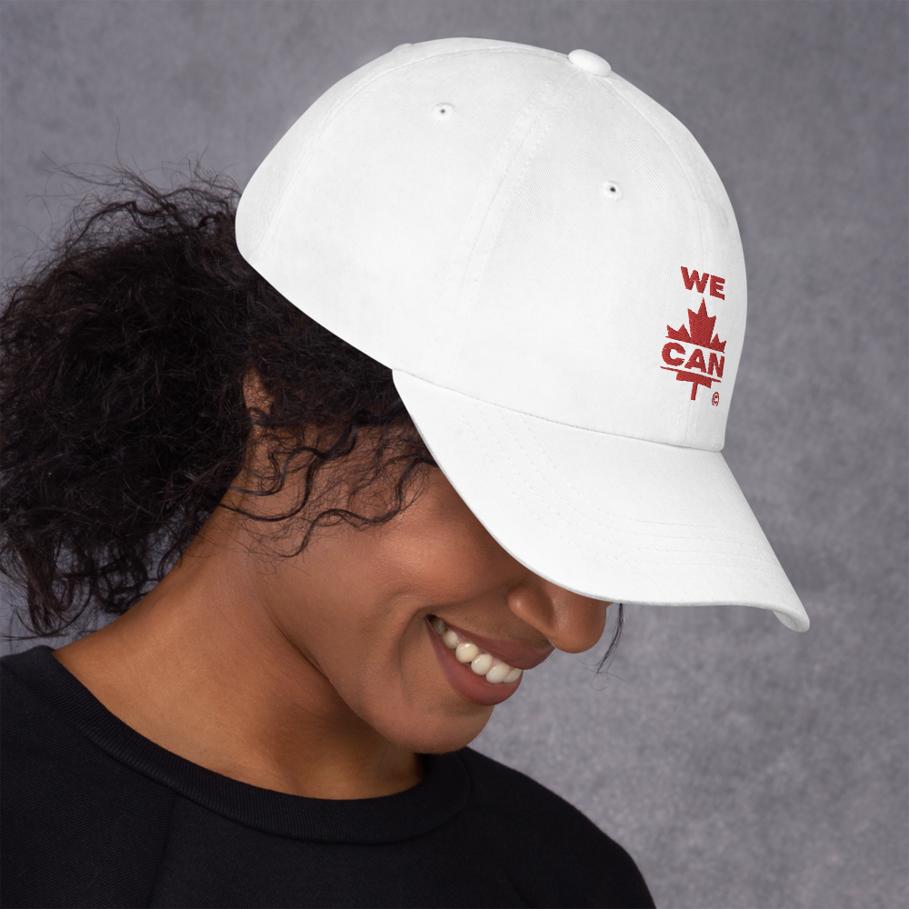 Woman wearing a white cap with red “WE CAN” maple leaf embroidery – minimalist Canadian statement design by CarolArtWorks.