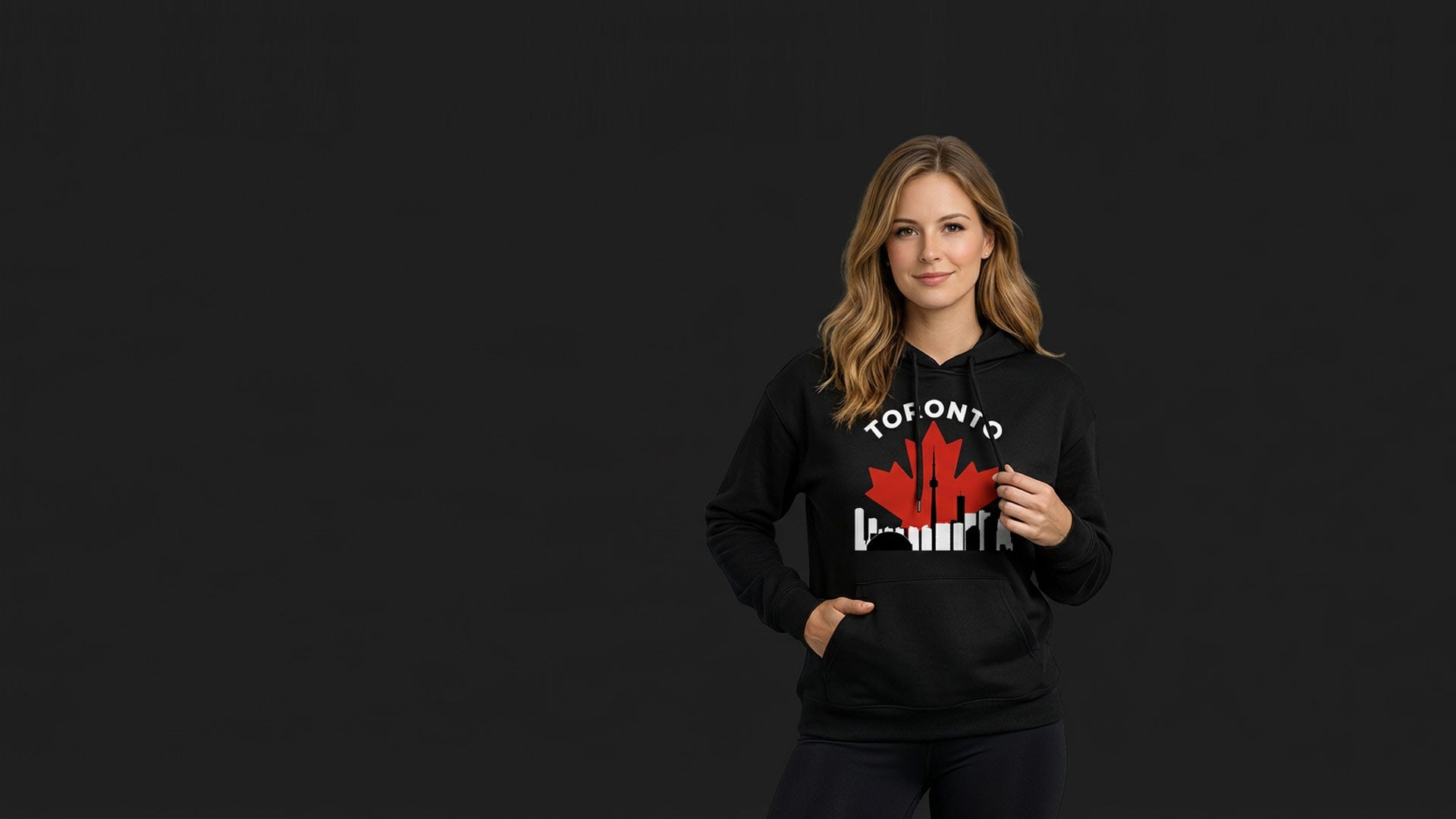 Woman wearing a black Toronto maple leaf hoodie with city skyline design – MapleLine Canadian streetwear hoodie