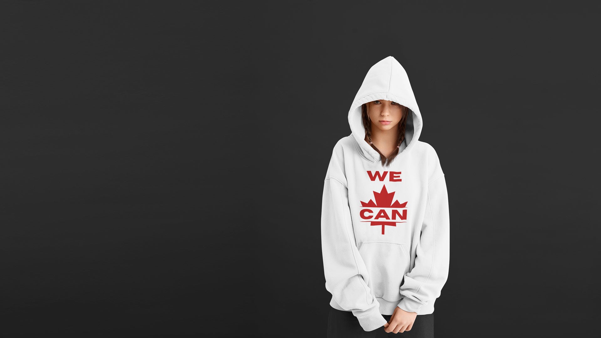 Youth model wearing a white hoodie with a bold red ‘WE CAN’ maple leaf design, representing Canadian pride and teen empowerment.